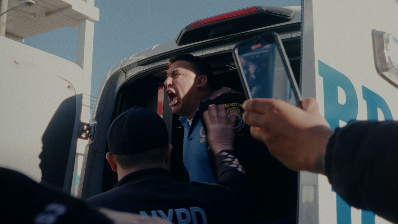 man shouting and surrounded by police